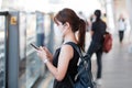 Young Asian woman wearing surgical face mask against Novel coronavirus or Corona Virus Disease Covid-19 at public train station Royalty Free Stock Photo