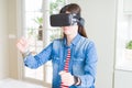 Young asian woman wearing virtual reality glasses smiling and concentrated playing video games of driving a car Royalty Free Stock Photo