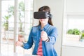 Young asian woman wearing virtual reality glasses smiling and concentrated playing video games of driving a car Royalty Free Stock Photo