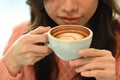 Young woman wearing warm sweater and drinking hot coffee at the morning. Royalty Free Stock Photo