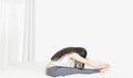 Beside of young asian woman wearing white undershirt and gray pants,exercising yoga while sitting on a white bed , stretch oneself Royalty Free Stock Photo