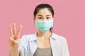 Young asian woman wore a gray undershirt, Blue shirt and protective masks against virus and air pollution,hand holding red heart,