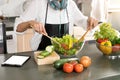 young asian woman work with tablet cooking Royalty Free Stock Photo