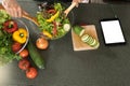 young asian woman work with tablet cooking Royalty Free Stock Photo