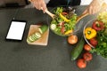 young asian woman work with tablet cooking Royalty Free Stock Photo