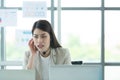 Young asian woman working at a call center Consulting about stock investment information with customers calling for advice with Royalty Free Stock Photo