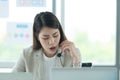 Young asian woman working at a call center Consulting about stock investment information with customers calling Royalty Free Stock Photo