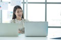 Young asian woman working at a call center Consulting about stock investment information with customers calling for advice Royalty Free Stock Photo