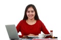 Young Asian woman at working desk looking at camera with smiling on white