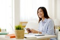 Young asian woman working with digital tablet at home office with happy emotion, working from home, small business, office casual Royalty Free Stock Photo