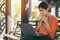 Young asian woman working with her laptop and she feel worried in the park outdoors on vacation time Royalty Free Stock Photo