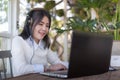 Young Asian woman working with laptop in coffee shop