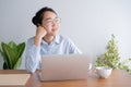 Young asian woman working on laptop in the home office desk. And sit at table resting chin on hand Royalty Free Stock Photo