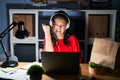 Young asian woman working at the office with laptop at night angry and mad raising fist frustrated and furious while shouting with Royalty Free Stock Photo