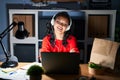 Young asian woman working at the office with laptop at night happy face smiling with crossed arms looking at the camera Royalty Free Stock Photo