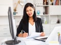 Young asian woman working in office and signs documents Royalty Free Stock Photo