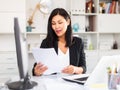 Young asian woman working in office and signs documents Royalty Free Stock Photo