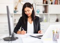 Young asian woman working in office and signs documents Royalty Free Stock Photo