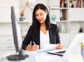 Young asian woman working in office and signs documents Royalty Free Stock Photo