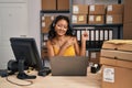 Young asian woman working at small business ecommerce wearing headset smiling and looking at the camera pointing with two hands Royalty Free Stock Photo