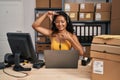 Young asian woman working at small business ecommerce wearing headset smiling making frame with hands and fingers with happy face Royalty Free Stock Photo