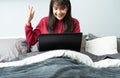 Young Asian woman works from home on tablet computer