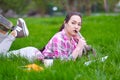 Young Asian woman writing in notebook lying on grass on meadow Royalty Free Stock Photo