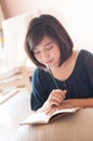 Young asian woman writing. Royalty Free Stock Photo