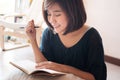 Young asian woman writing. Royalty Free Stock Photo