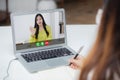 Young asian woman writing on notebook for planning working and using laptop computer blank screen on desk at home. Royalty Free Stock Photo