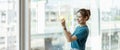 Young asian woman writing text on sticky notes to share idea sticky note on glass wall. Brainstorming Royalty Free Stock Photo