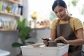 Young asian woman's hands close up, the masterful studio of ceramics works with clay on a potter's wheel. Royalty Free Stock Photo