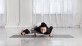 Young asian woman in yoga class making asana exercises. Girl do Eight Angle Pose. Healthy lifestyle in fitness club. Royalty Free Stock Photo