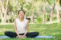 Young asian woman yoga outdoors keep calm and meditates while practicing yoga to explore the inner peace. Royalty Free Stock Photo