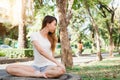 Young asian woman yoga outdoors keep calm and meditates while practicing yoga to explore the inner peace. Royalty Free Stock Photo