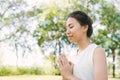 Young asian woman yoga outdoors keep calm and meditates while practicing yoga to explore the inner peace. Royalty Free Stock Photo