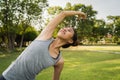 Young asian woman yoga outdoors keep calm and meditates while practicing yoga.