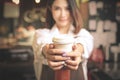 Young asian women barista hold coffee cup serving at the coffee shop