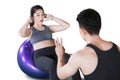 Asian woman doing sit ups with her trainer Royalty Free Stock Photo