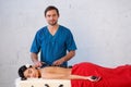 Young Asian woman enjoying the therapeutic effects of a traditional hot stone massage at luxury spa and wellness center Royalty Free Stock Photo