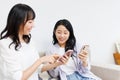 Young  women with mobile phones chatting at home Royalty Free Stock Photo