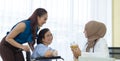 Young asian woman muslim doctor holding the bottle of pills and explaining to elderly patient with her daughter in the hospital Royalty Free Stock Photo