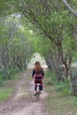 Young asian women rideing an old bike in field.