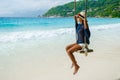 Young Asian women at a swing on a tropical beach in Mahe Tropical Seychelles Islands Royalty Free Stock Photo