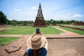 Young Asian women tourist taking photo picture with camera and traveling at Wat Chaiwatthanaram, ancient buddhist temple, famous Royalty Free Stock Photo
