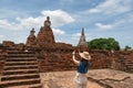 Young Asian women tourist taking photo picture with camera and traveling at Wat Chaiwatthanaram, ancient buddhist temple, famous Royalty Free Stock Photo