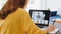 Asian woman video call conference, online remote meeting with business coworker, at home. New normal lifestyle Royalty Free Stock Photo