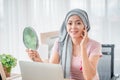 Young asian women wearing hijab Look in the mirror at your desk Represents recovery from a breast cancer illness. breast cancer Royalty Free Stock Photo