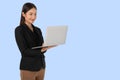 Young Asian working woman with smiling face using Laptop computer isolated on light blue background. Royalty Free Stock Photo