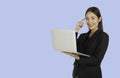 Young Asian working woman using laptop computer and thinking. Royalty Free Stock Photo